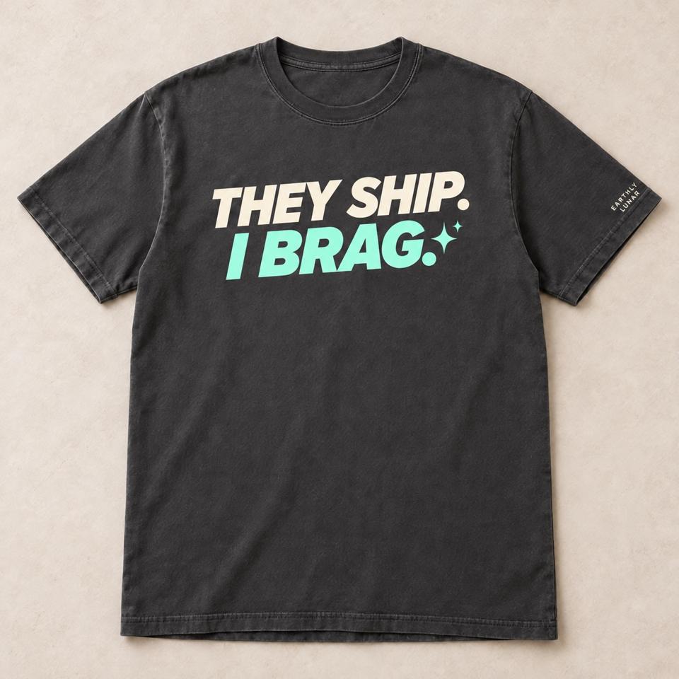 Charcoal tee with 'THEY SHIP.' in bold slanted cream capitals over 'I BRAG.' in mint, with a sparkle