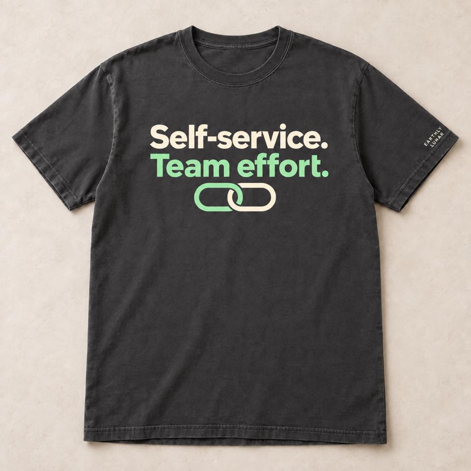 Charcoal tee with 'Self-service.' in cream and 'Team effort.' in mint over two linked mint rings